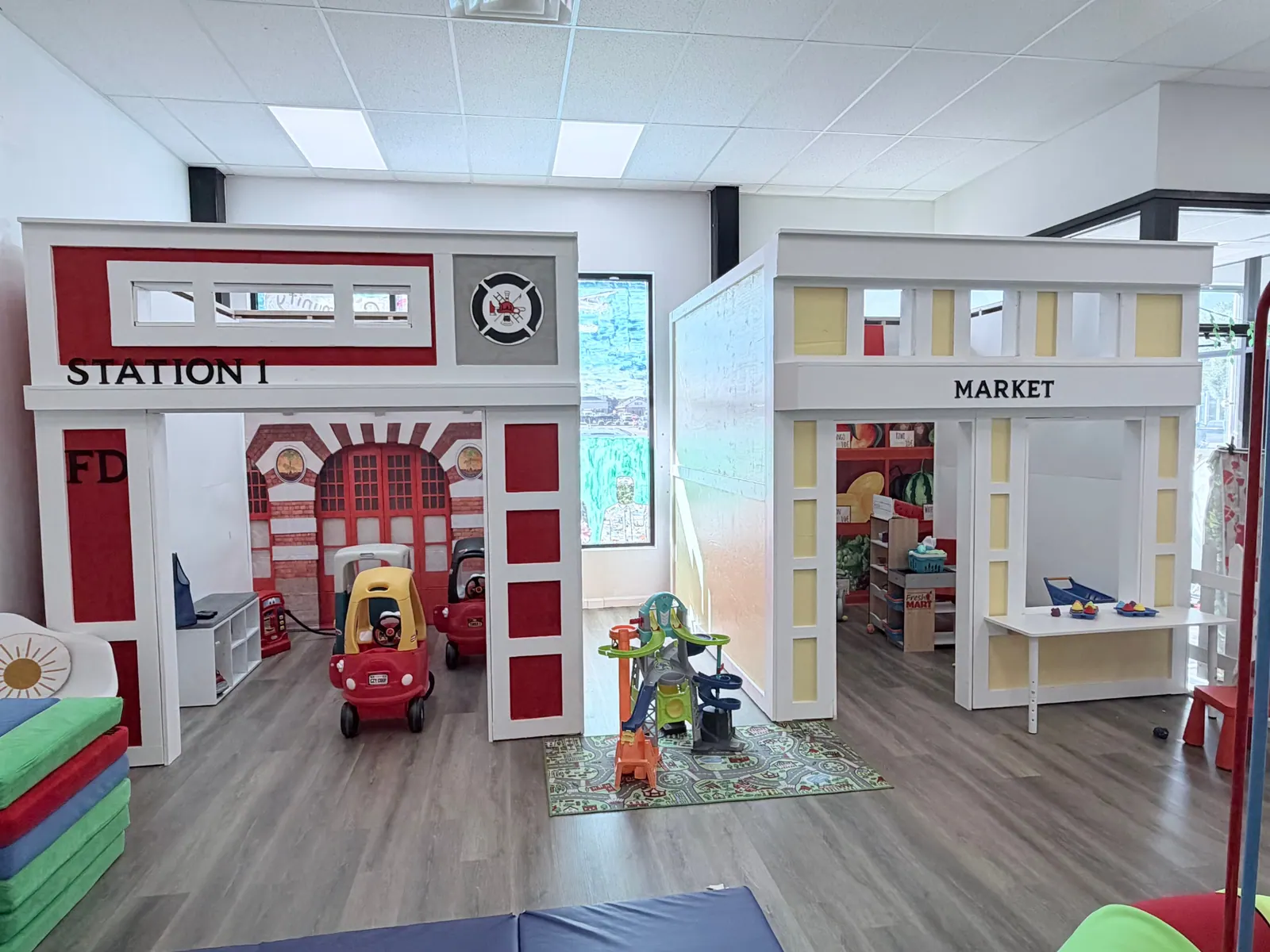 The Station 1 firehouse and Market playhouses on the Catalillies play floor